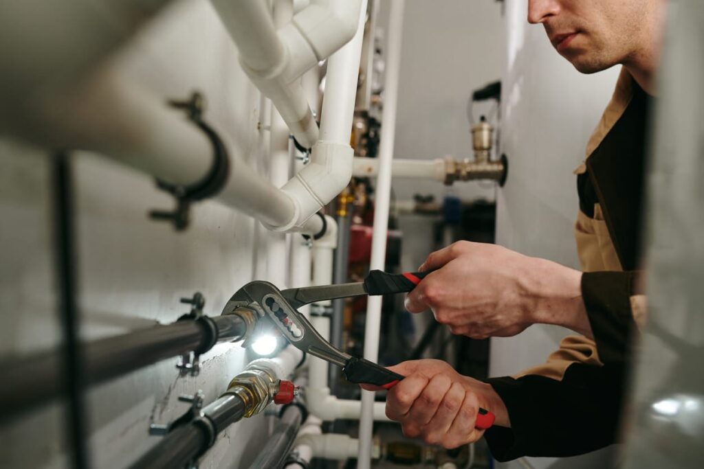 Plumbers maintaining commercial plumbing pipes in Winder
