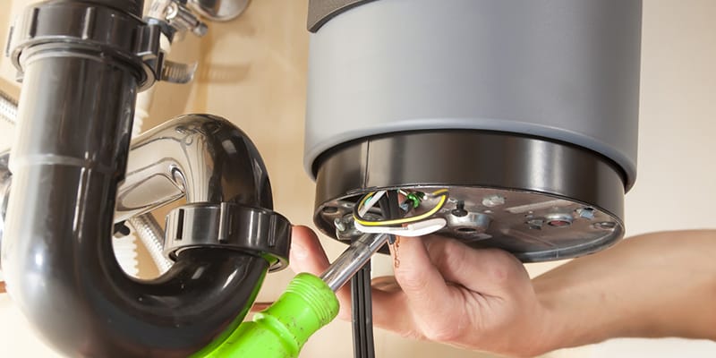 Technician repairing the heating element of a water heater in Winder