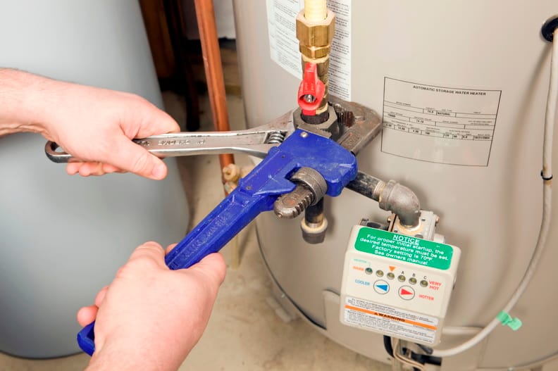 Plumber repairing a water heater valve in Winder